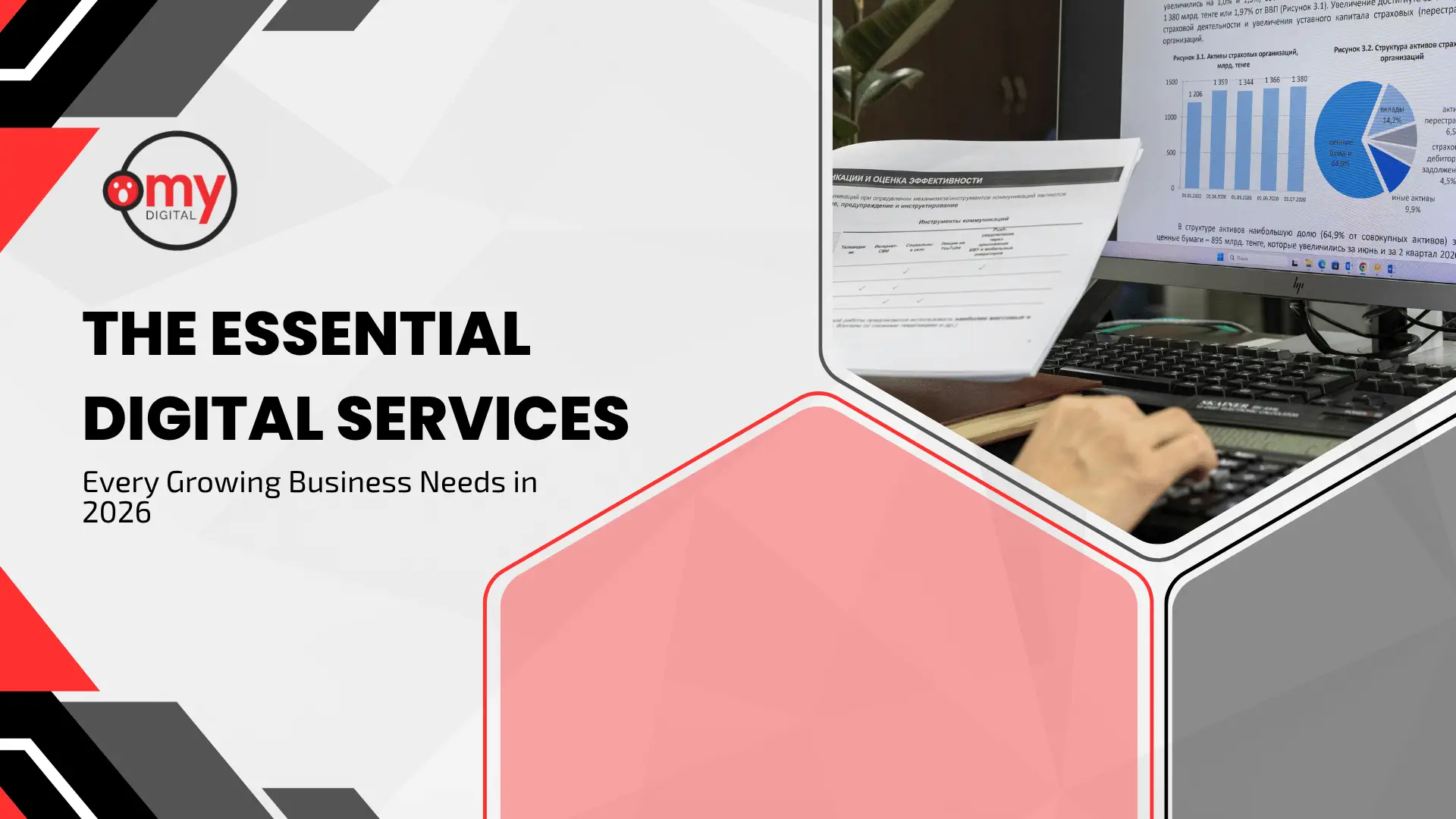 A modern corporate blog banner designed with a clean white and light gray background, framed by sharp black and red geometric shapes in the corners. On the top left, the circular logo for "Omy Digital" is displayed above the prominent black text headline: "THE ESSENTIAL DIGITAL SERVICES Every Growing Business Needs in 2026." The right half of the banner features a large, rounded hexagonal cutout showing a close-up of a person's hand typing on a black computer keyboard, with a document being held up in front of a desktop monitor displaying colorful data bar charts and graphs.